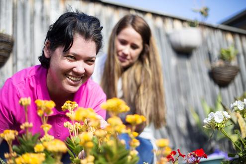 client and support worker in the garden