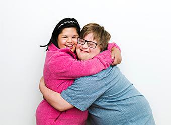 two clients hugging happy to be roommates
